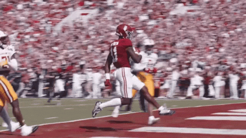 A Football Player In A Red Jersey With The Number 8 On It GIF