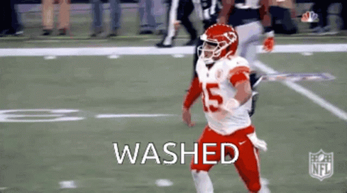 A Football Player In A Red Uniform Is Running On A Field With The Word Washed . GIF