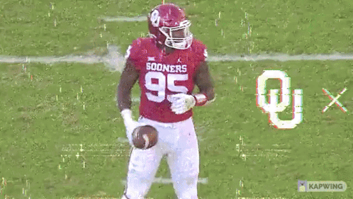 A Football Player In A Red Uniform With The Number 35 On It GIF