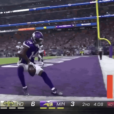 A Football Player In A Vikings Uniform Runs Towards The Goal Line GIF