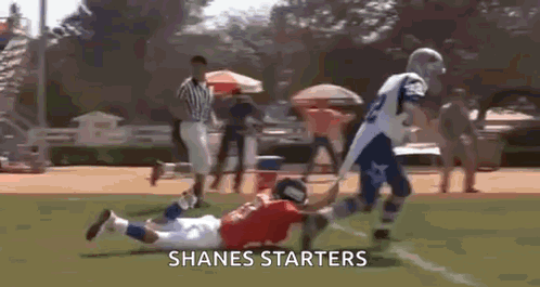 a football player is being tackled by another player on a field with the words shanes starters on the bottom .