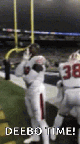 A Football Player Is Catching A Ball On The Field While Another Player Says Deebo Time . GIF