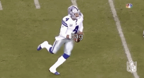 A Football Player Is Kneeling Down On The Field While Another Player Runs Behind Him . GIF