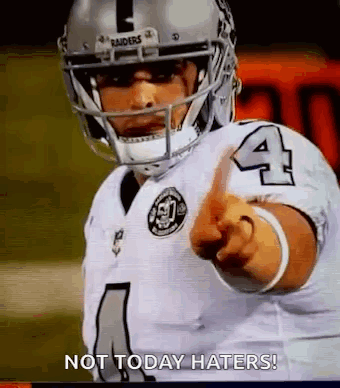A Football Player Is Pointing At The Camera While Wearing A Helmet And Pointing At The Camera . GIF