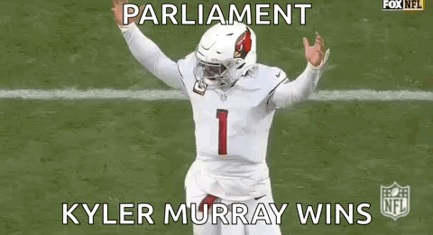 A Football Player Is Running On A Field While Wearing A White Jersey And A Helmet . GIF