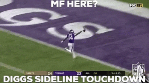 A Football Player Is Running On The Field While Holding A Ball . GIF