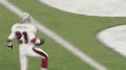 A Football Player Is Running On The Field While Wearing A Number 21 Jersey . GIF