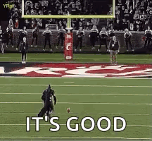 a football player is running with a ball on a field and the words `` it 's good '' are visible .