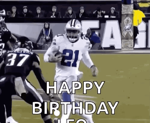 A Football Player Is Running With The Ball On A Field While Another Player Tries To Stop Him . GIF