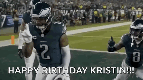 A Football Player Is Running With The Ball On A Field While Giving A Thumbs Up . GIF