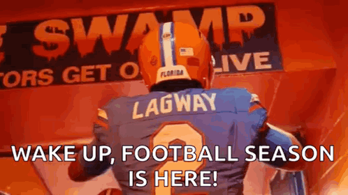 A Football Player Is Standing In Front Of A Sign That Says Wake Up , Football Season Is Here ! GIF