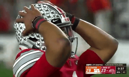 A Football Player Is Wearing A Helmet That Says Buckeyes On It GIF