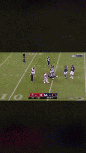 A Football Player Kneeling On The Field With The Number 16 On His Jersey GIF