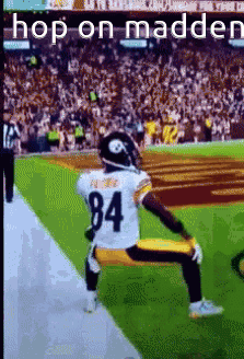 A Football Player Kneeling On The Field With The Number 84 On His Jersey . GIF