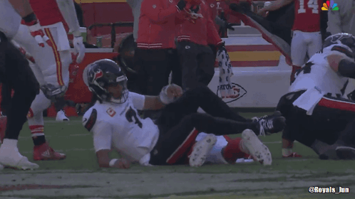 A Football Player Laying On The Field With The Number 4 On The Back Of His Jersey GIF