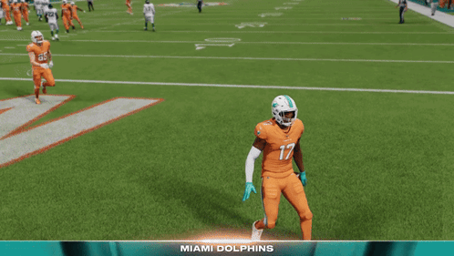 A Football Player Named Jaylen Waddle Is Standing On The Field GIF