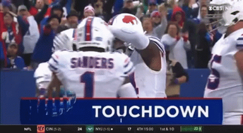 A Football Player Named Sanders Is Celebrating A Touchdown With His Teammates GIF