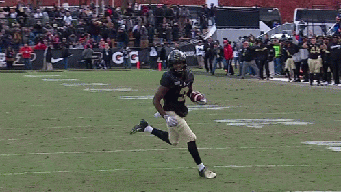 a football player running on the field with the number 45 on his jersey
