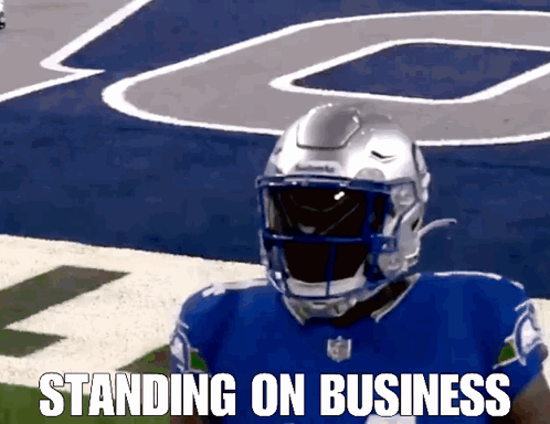 A Football Player Standing On A Field With The Words Standing On Business Written Below Him GIF