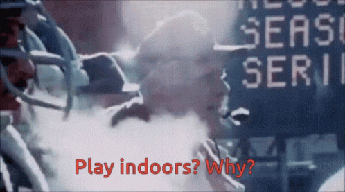 A Football Player Stands In Front Of A Scoreboard That Says " Play Indoors " GIF