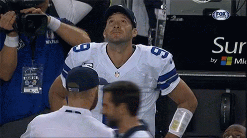 A Football Player Stands In Front Of A Sign That Says Sur By Mic GIF