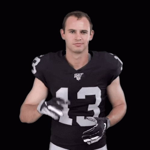 A Football Player Wearing A Black Jersey With The Number 13 On It GIF