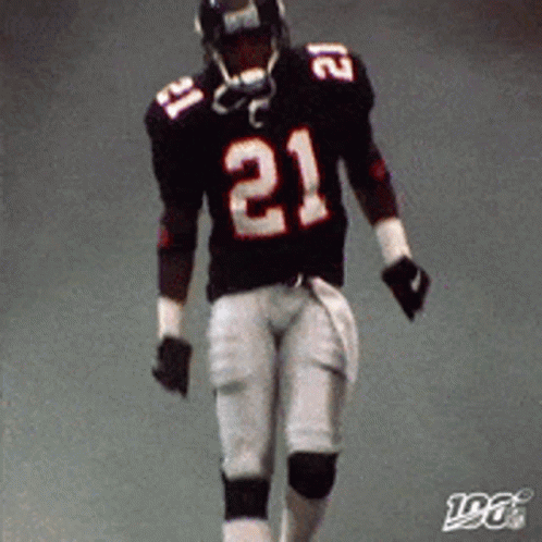 A Football Player Wearing A Black Jersey With The Number 21 On It GIF