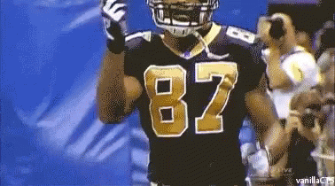 a football player wearing a black jersey with the number 82 on it
