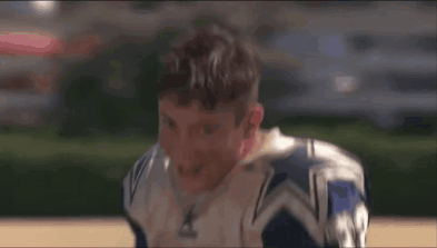 A Football Player Wearing A Blue And White Jersey With The Number 31 On It Is Smiling . GIF