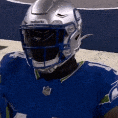 A Football Player Wearing A Blue Jersey And A Helmet GIF