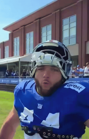 A Football Player Wearing A Blue Jersey That Says Ny GIF