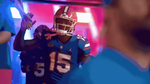 a football player wearing a blue jersey with the number 15