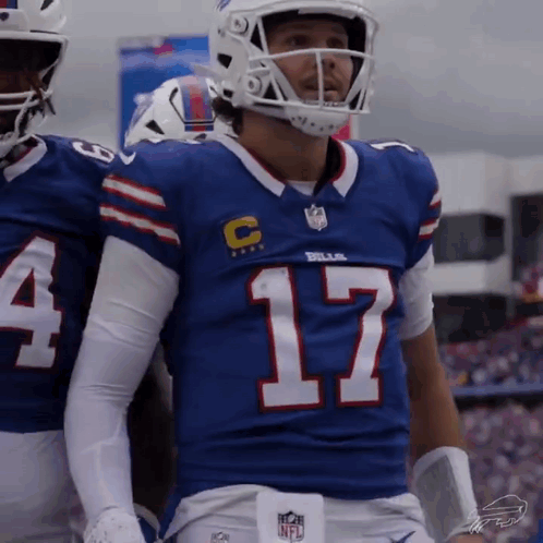 A Football Player Wearing A Blue Jersey With The Number 17 On The Front GIF