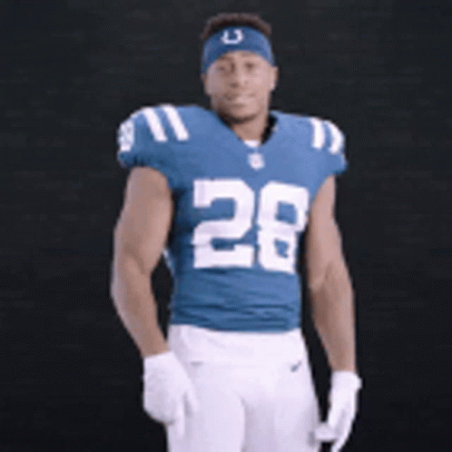 A Football Player Wearing A Blue Jersey With The Number 28 GIF