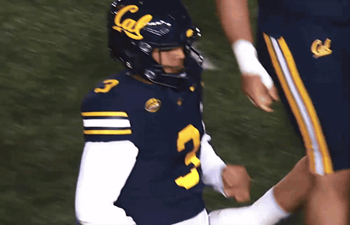 A Football Player Wearing A Blue Jersey With The Number 3 GIF