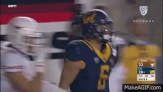 A Football Player Wearing A Blue Jersey With The Number 33 On It GIF