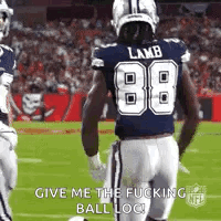 A Football Player Wearing A Blue Jersey With The Number 88 On It Is Running On The Field . GIF
