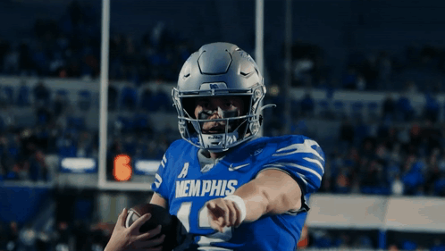a football player wearing a blue memphis jersey