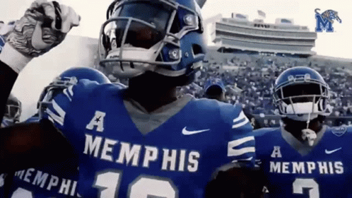 a football player wearing a blue memphis jersey