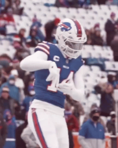 A Football Player Wearing A Buffalo Bills Uniform Is Running On A Field . GIF
