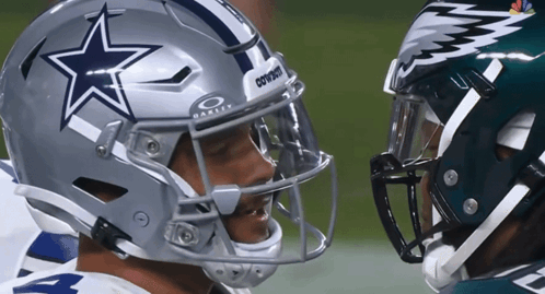 A Football Player Wearing A Cowboys Helmet Talks To Another Player GIF