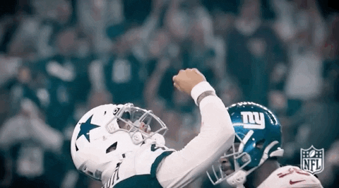 A Football Player Wearing A Cowboys Jersey And A New York Giants Helmet Celebrates A Touchdown . GIF