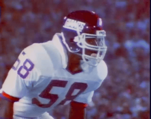 A Football Player Wearing A Giants Helmet And Number 58 On His Jersey GIF