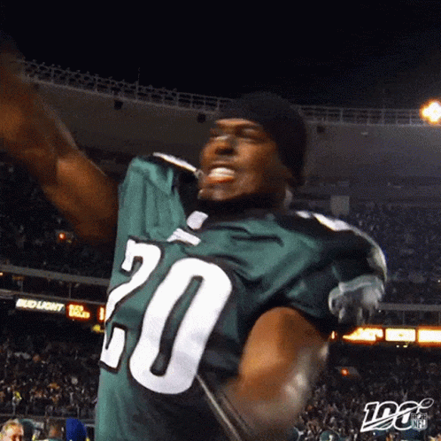 A Football Player Wearing A Green Jersey With The Number 20 GIF