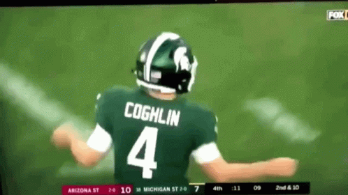 A Football Player Wearing A Green Jersey With The Number 4 On It GIF