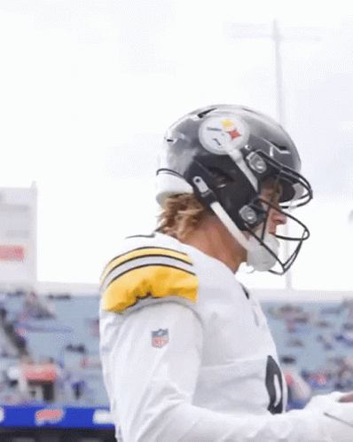 A Football Player Wearing A Helmet And A White Shirt With The Number 9 On It GIF