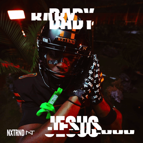 A Football Player Wearing A Helmet And Gloves With The Word Jesus On It GIF