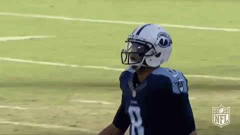 A Football Player Wearing A Helmet And Number 8 Jersey Is Standing On The Field . GIF
