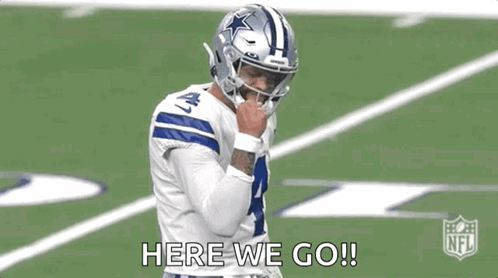 A Football Player Wearing A Helmet Is Standing On A Field . GIF