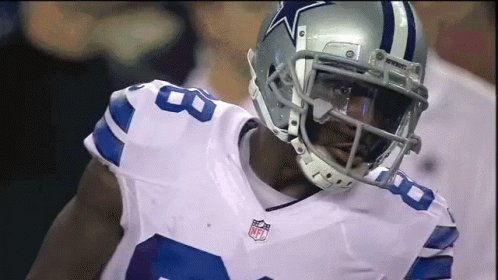 A Football Player Wearing A Helmet That Has A Star On It GIF